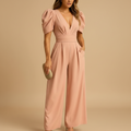 woman wearing full length elegant jumpsuit with flowing silhouette shown in full front view outfit