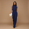 woman wearing halter neck wide leg jumpsuit with sleeveless design shown in full front view outfit
